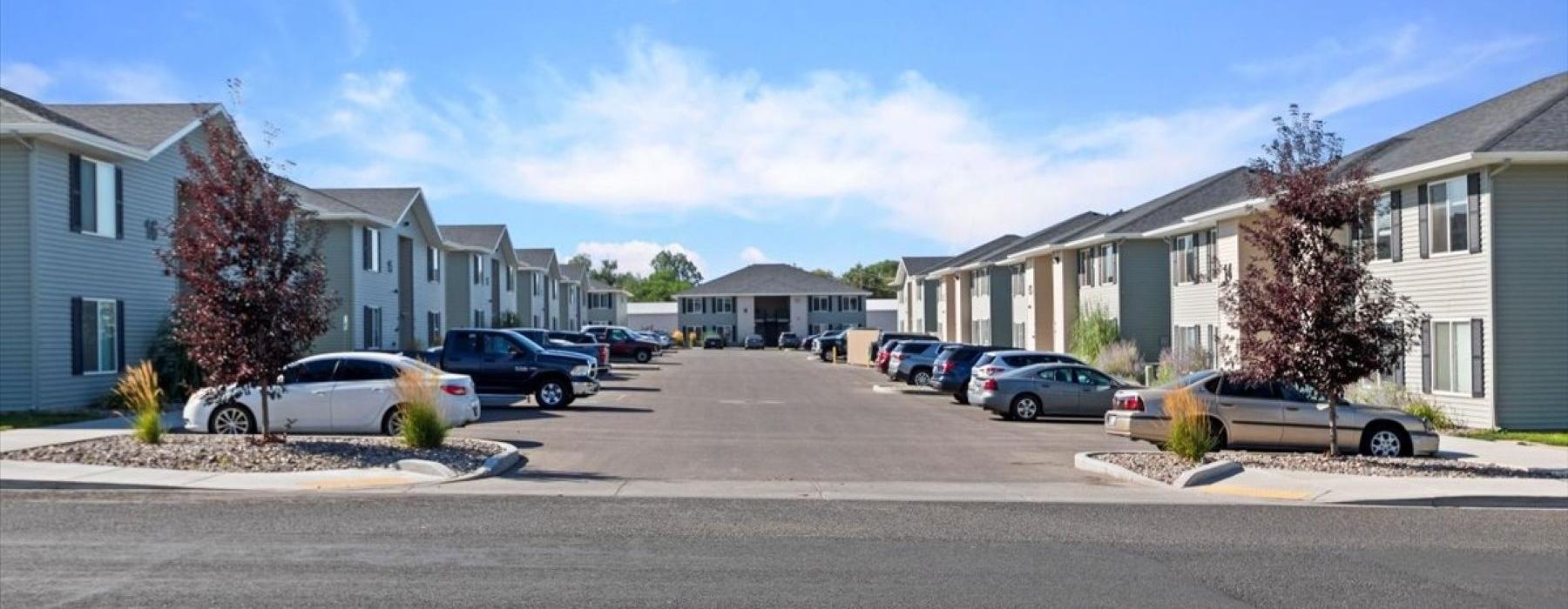 a neighborhood street with cars parked