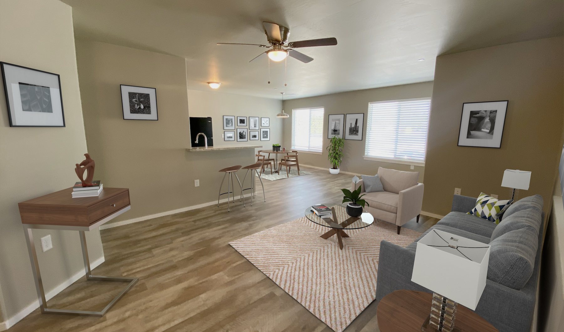 a living room with a couch a rug a table and windows