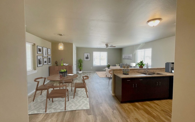 living area with a dining table and chairs and kitchen island