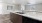a kitchen with a marble countertop and sink