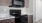 a kitchen with a black stove and microwave