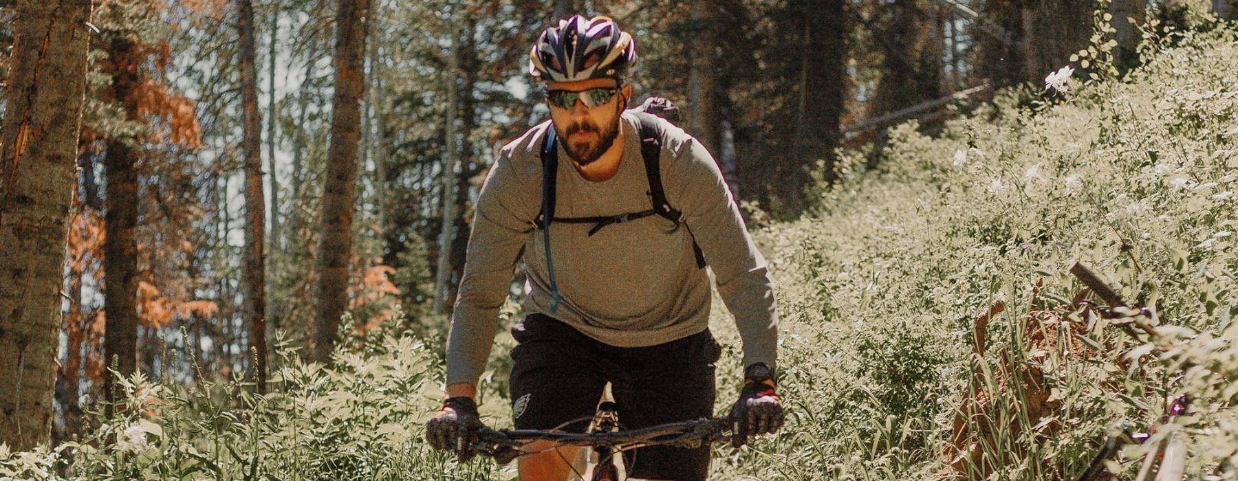 man riding a bike on a trail in the woods